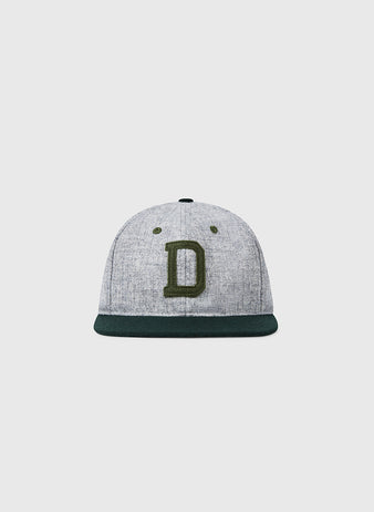 The EFF Dartmouth College 1942 Vintage Ballcap features gray wool, a dark green brim, and a large embroidered green D, authentically reproducing the classic style of the original, displayed on a plain light background.