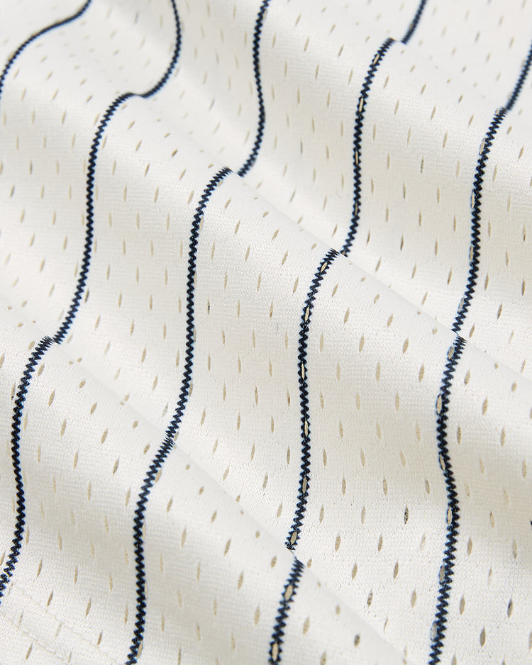 A close-up of the lightweight, textured white mesh of the Ebbets Field San Francisco Seals 1940 Mesh Button-Up Jersey, featuring small oval perforations and wavy blue stitched lines reminiscent of classic Seals uniforms.