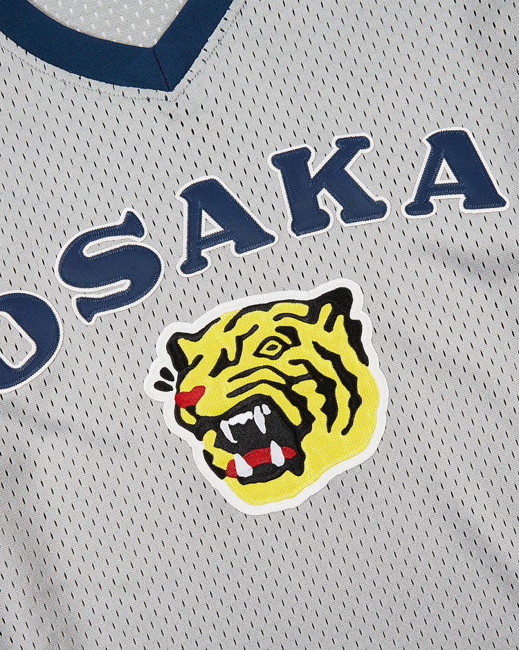 A close-up of the Osaka Tigers Mesh V-Neck Jersey by Ebbets Field, featuring blue 