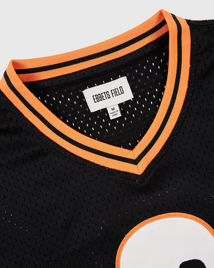 Close-up of the Ebbets Field Sioux City Ghosts Mesh V-Neck Jersey, featuring orange and white trim, a visible brand label, and a bold white circular graphic that highlights the team's classic fast-pitch softball style.