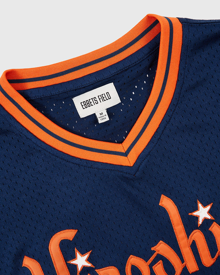 Close-up of the Ebbets Field Hiroshima Carp Mesh V-Neck Jersey in navy blue, featuring orange-striped collar and trim. The label displays 