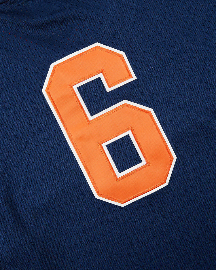 A bold orange number 6 with a white outline appears on blue mesh fabric, echoing classic Japanese baseball looks and Hiroshima Carp team heritage, featured on the Ebbets Field Hiroshima Carp Mesh V-Neck Jersey.