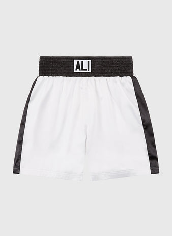 Ebbets Field's Muhammad Ali Vintage Inspired Boxing Trunks honor the 50th anniversary of the Thrilla in Manila with white fabric, black side panels, a wide black waistband, and bold “ALI” lettering—a timeless tribute to a boxing legend.