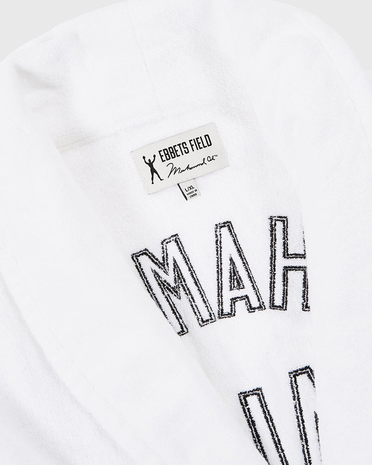 Close-up of the Muhammad Ali Cotton Terry Boxing Robe by Ebbets Field, featuring black embroidery, labels with 