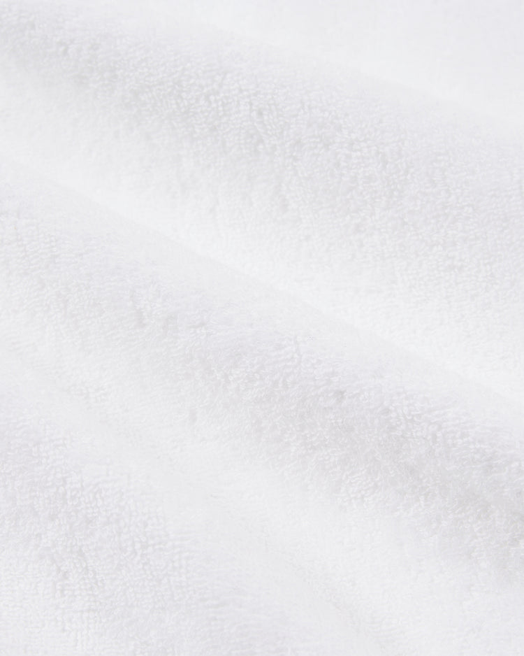 Close-up of the soft, textured cotton terry fabric from the Ebbets Field Muhammad Ali Boxing Robe, highlighting its plush white fibers and gentle folds reminiscent of classic boxing apparel.