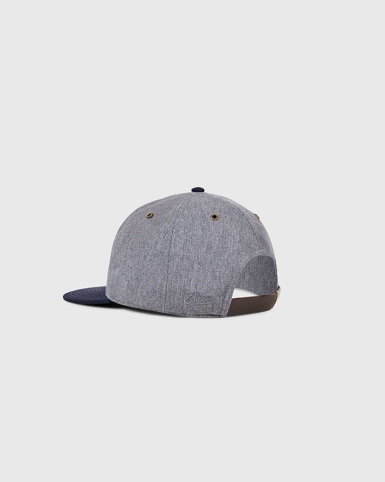 The Ebbets Field Hiroshima Carp Cotton Twill Ballcap is shown from the back in grey and navy, featuring a brown adjustable strap and brass eyelets against a plain light grey background.