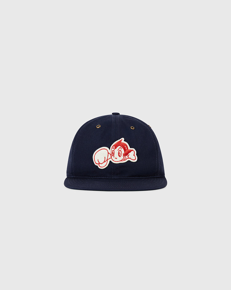 The Ebbets Field Sankei Atoms Cotton Twill Ballcap is a navy cap with a cartoon Astro Boy patch showing his iconic large fist on the front, displayed against a plain light gray background.