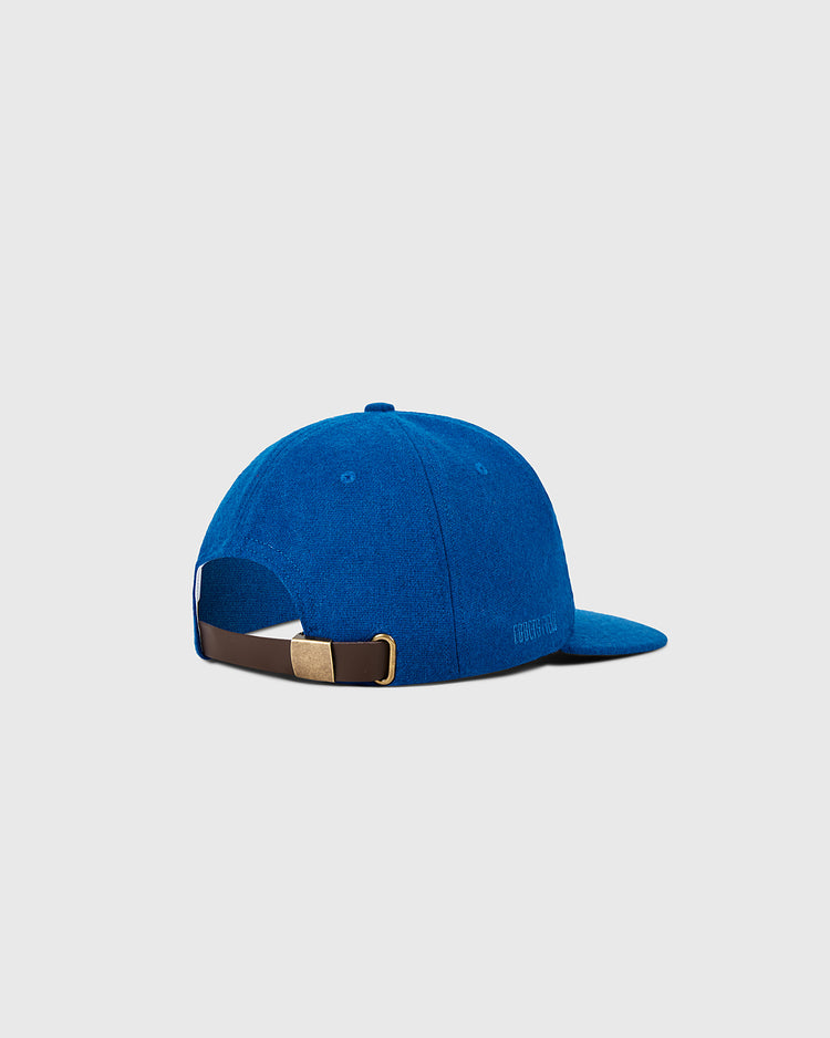 The Ebbets Field New York Mets 1962 MLB Authentic Wool Ballcap, shown from the back, features a blue wool design with a curved brim, brown adjustable strap with gold buckle, and is set against a plain light gray background.