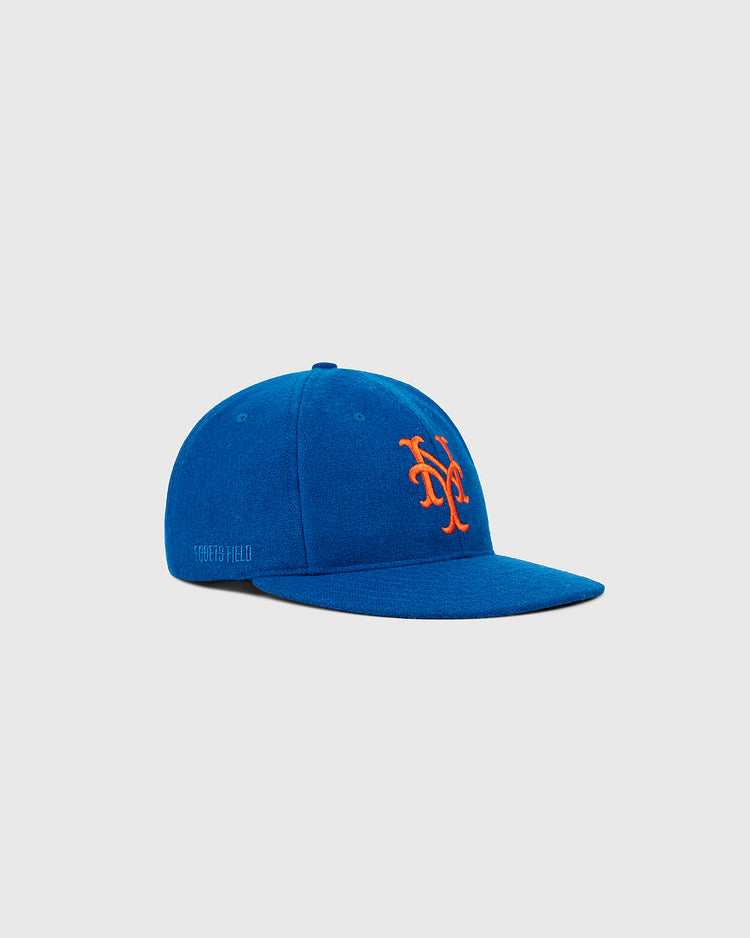 The Ebbets Field New York Mets 1962 MLB Authentic Wool Ballcap, featuring a blue body and orange NY logo, is showcased at an angle on a plain gray background.