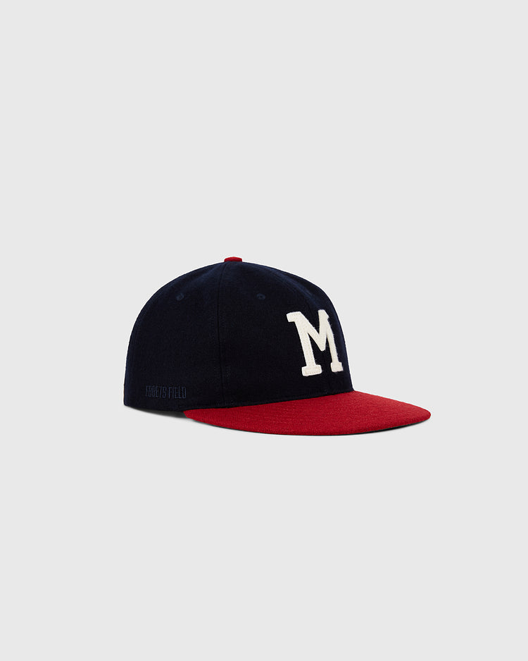 The Ebbets Field Milwaukee Braves 1953 MLB Authentic Wool Ballcap features a navy blue crown, large white “M” on the front, and red brim from the Decade of Change Collection, shown against a plain light gray background.