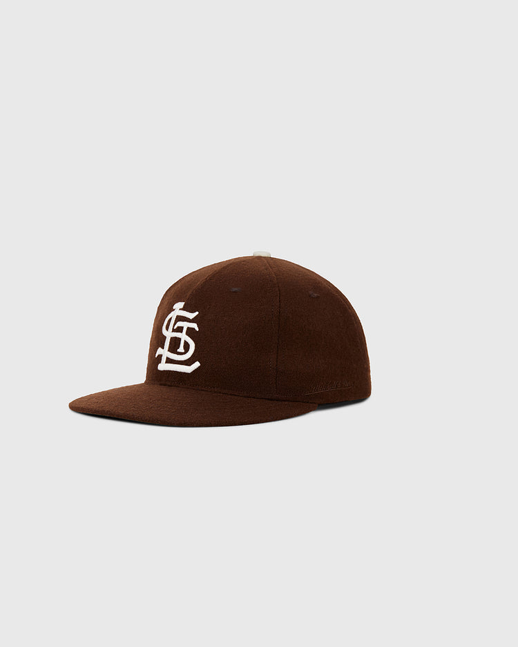 The Ebbets Field St. Louis Browns 1953 MLB Authentic Wool Ballcap showcases a brown wool cap with a white interlocking STL logo on the front, inspired by the Decade of Change Collection, shown on a light gray background.