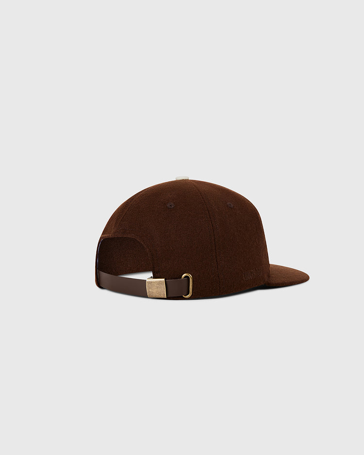 The St. Louis Browns 1953 MLB Authentic Wool Ballcap by Ebbets Field, shown from the back with a dark brown leather strap and brass buckle, is set against a light gray background. Part of the Decade of Change Collection.