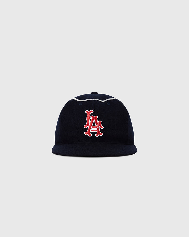 The Ebbets Field Los Angeles Angels 1961 MLB Authentic Wool Ballcap features a navy blue design with a red and white embroidered LA logo, reminiscent of the original, displayed on a plain light gray background.