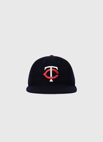The Ebbets Field Minnesota Twin 1961 MLB Authentic Wool Ballcap features a navy blue design with a red and white TC logo, inspired by the original on-field cap and displayed against a plain light gray background.