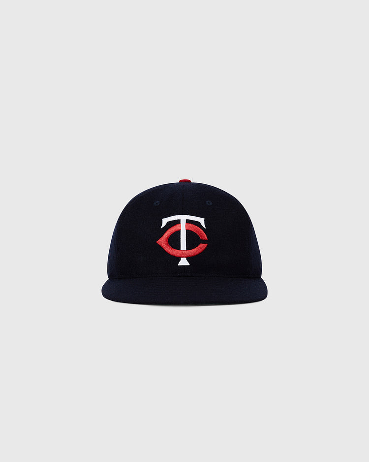 The Ebbets Field Minnesota Twin 1961 MLB Authentic Wool Ballcap features a navy blue design with a red and white TC logo, inspired by the original on-field cap and displayed against a plain light gray background.