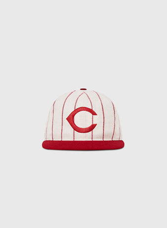The Ebbets Field Cincinnati Reds 1958 MLB Authentic Wool Ballcap features red vertical pinstripes, a red brim, and a bold red C on the front, displayed against a plain light background.