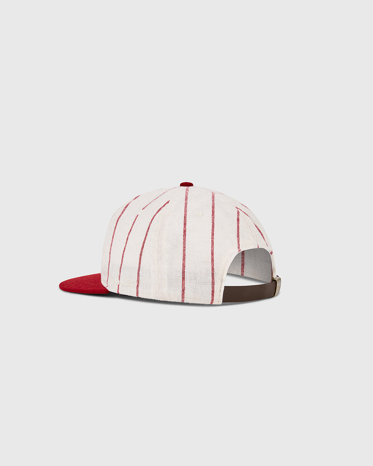 The Ebbets Field Cincinnati Reds 1958 MLB Authentic Wool Ballcap features white wool with thin red stripes, a red brim, and an adjustable brown strap, shown against a plain light background.