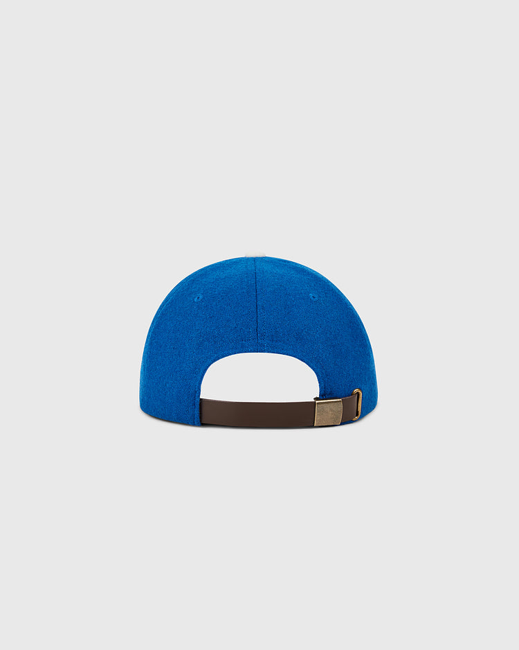 Back view of a blue Ebbets Field Brooklyn Dodgers 1955 MLB Authentic Wool Ballcap with a brown adjustable strap and metal clasp, displayed against a plain light gray background.
