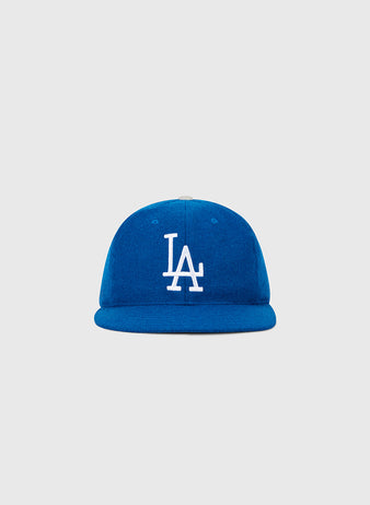 The Ebbets Field Los Angeles Dodgers 1958 MLB Authentic Wool Ballcap is a blue cap with a white LA logo on the front, shown against a plain light gray background.