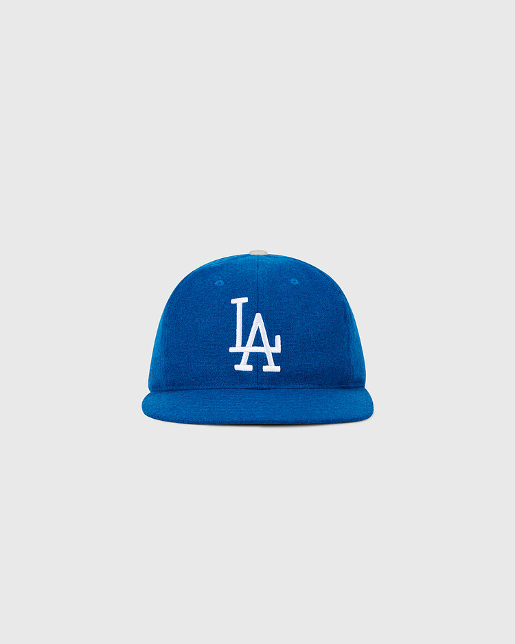 The Ebbets Field Los Angeles Dodgers 1958 MLB Authentic Wool Ballcap is a blue cap with a white LA logo on the front, shown against a plain light gray background.