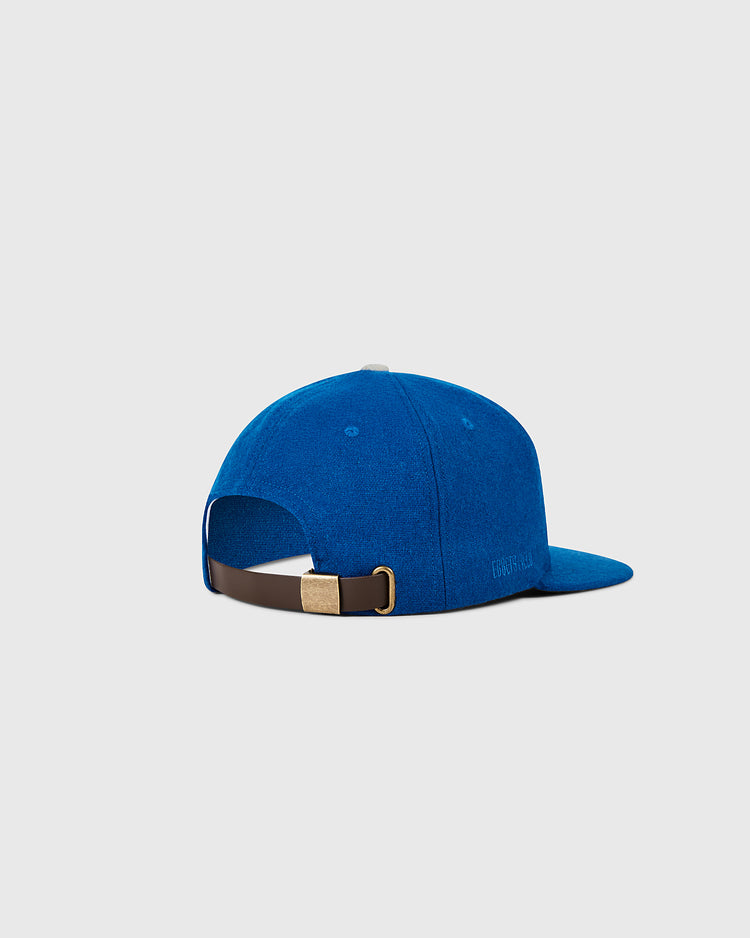 The Ebbets Field Los Angeles Dodgers 1958 MLB Authentic Wool Ballcap is shown from the back, displaying a brown leather strap with gold buckle for adjustment, set against a light gray background. Part of the Decade of Change Collection.