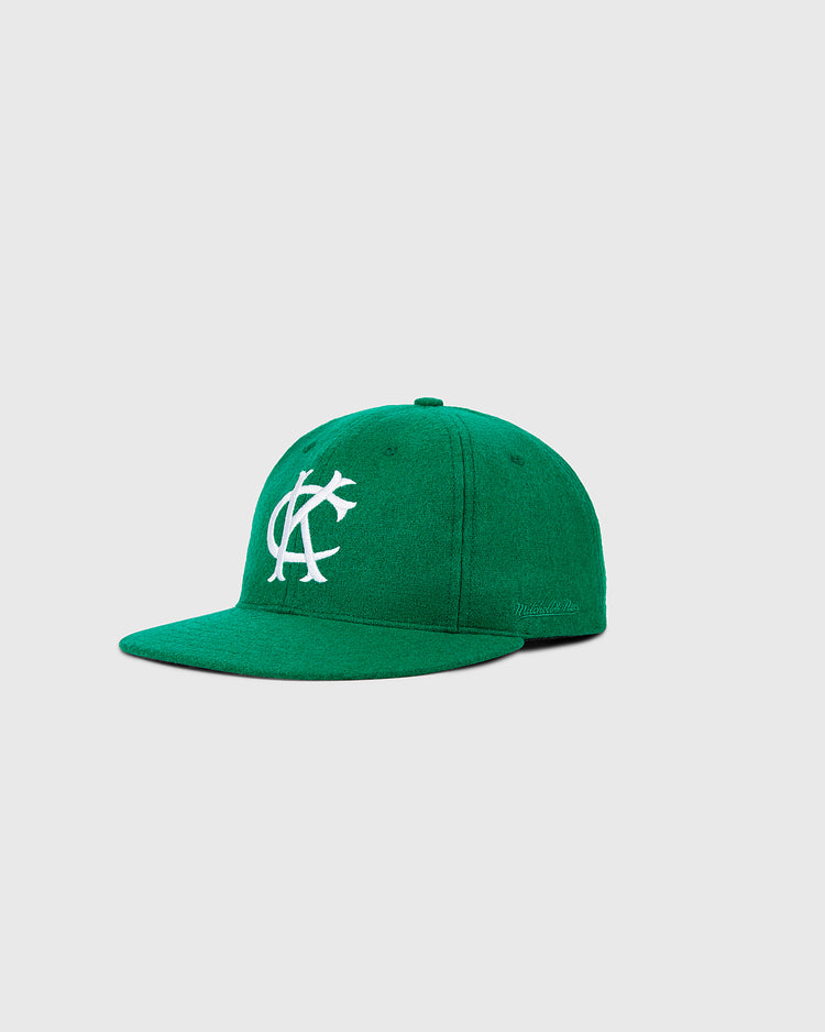 The Ebbets Field Kansas City Athletics 1963 MLB Authentic Wool Ballcap is a green cap with a white KC logo and curved bill, inspired by the original on-field style, shown against a plain light gray background.