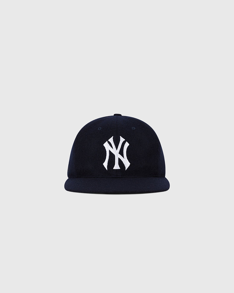 The Ebbets Field New York Yankees 1961 MLB Authentic Wool Ballcap features a navy blue design with a white NY logo, inspired by the original team cap and shown on a plain light grey background.