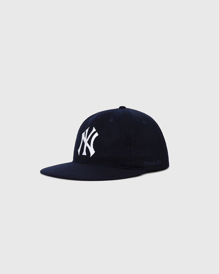 The Ebbets Field New York Yankees 1961 MLB Authentic Wool Ballcap features a navy blue design with a white NY logo, inspired by the original on-field cap, shown here against a light gray background.