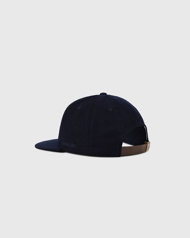 The Ebbets Field New York Yankees 1961 MLB Authentic Wool Ballcap features navy wool, a curved brim, and a brown adjustable strap, displayed on a light gray background. Part of the Decade of Change Collection.