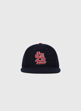 The Ebbets Field St. Louis Cardinals 1963 MLB Authentic Wool Ballcap features a navy design with a red and white interlocking STL logo, shown on a plain light gray background. Part of the Decade of Change Collection.