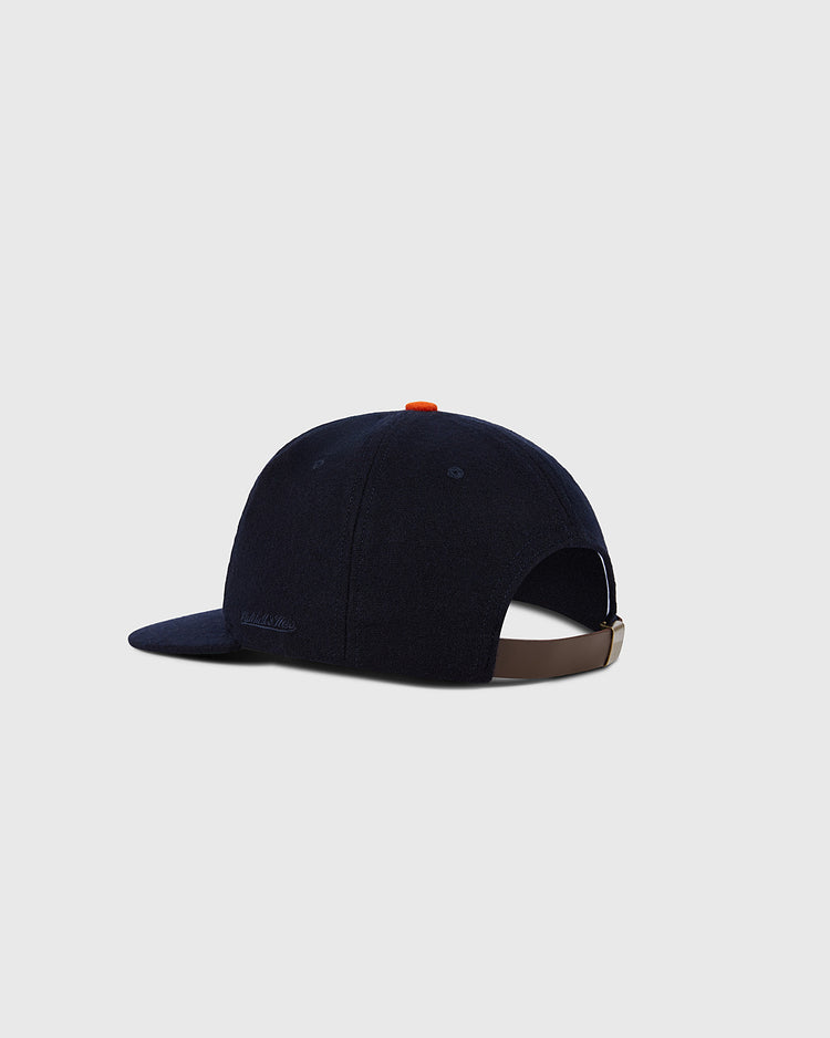 The Ebbets Field Houston Colt .45s 1962 MLB Authentic Wool Ballcap, in navy blue with a brown adjustable strap, is shown from behind at an angle on a plain light gray background. Part of the Decade of Change Collection.