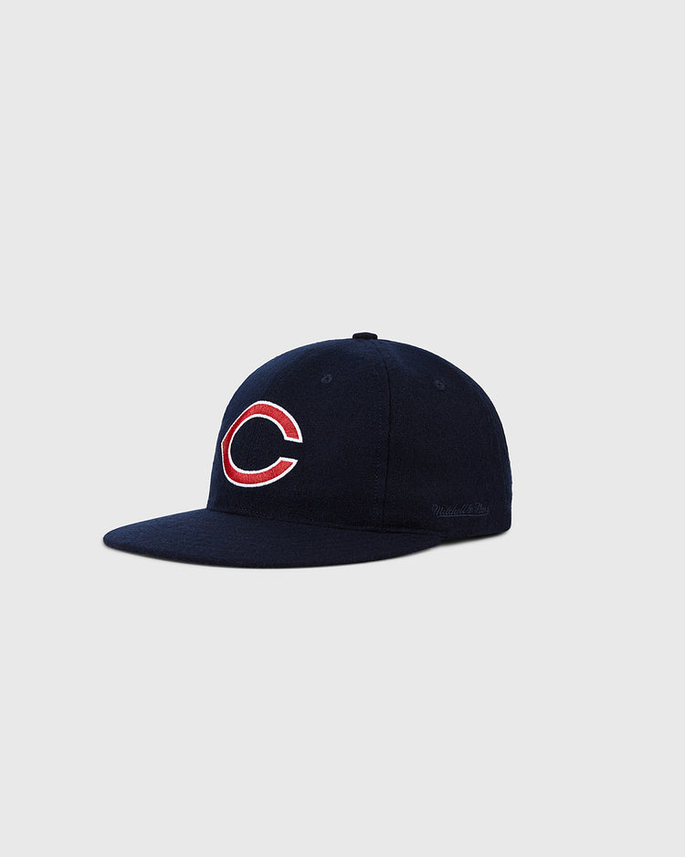 The Ebbets Field Cleveland Indians 1958-1961 MLB Authentic Wool Ballcap, a navy blue vintage hat with a red and white C logo on the front, is shown on a plain light gray background.