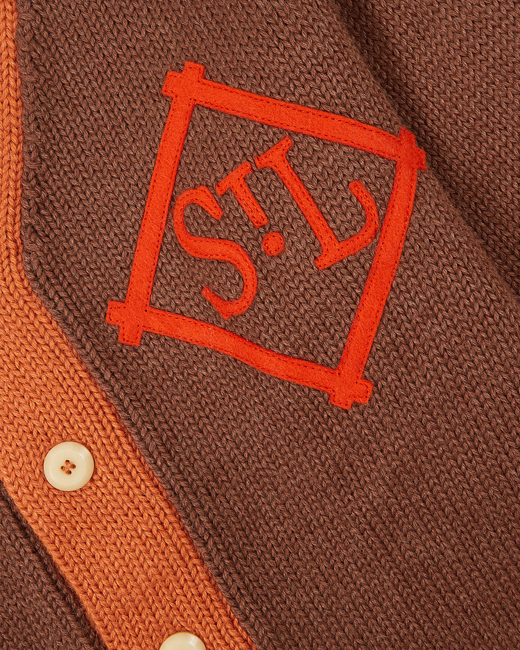 Close-up of the EFF St. Louis Browns 1909 Wool Cardigan Sweater, featuring brown knit fabric, beige buttons, and an orange “STL” patch inspired by the team’s classic vintage style.