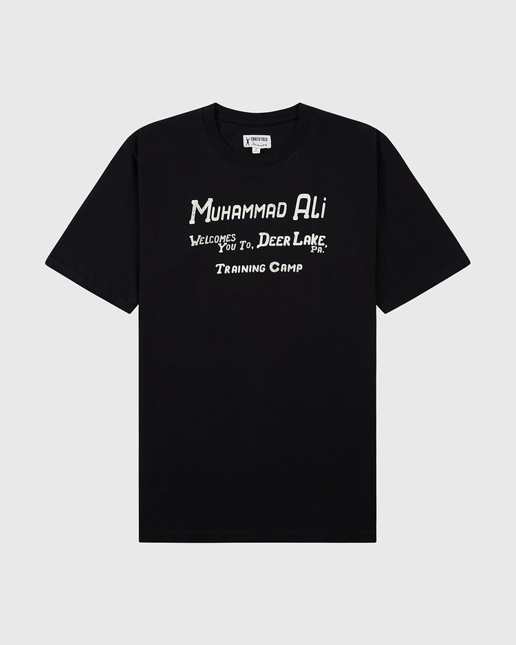 The Ebbets Field Muhammad Ali 'Deer Lake Training Camp' Short Sleeve Graphic Tee features a black design with white 