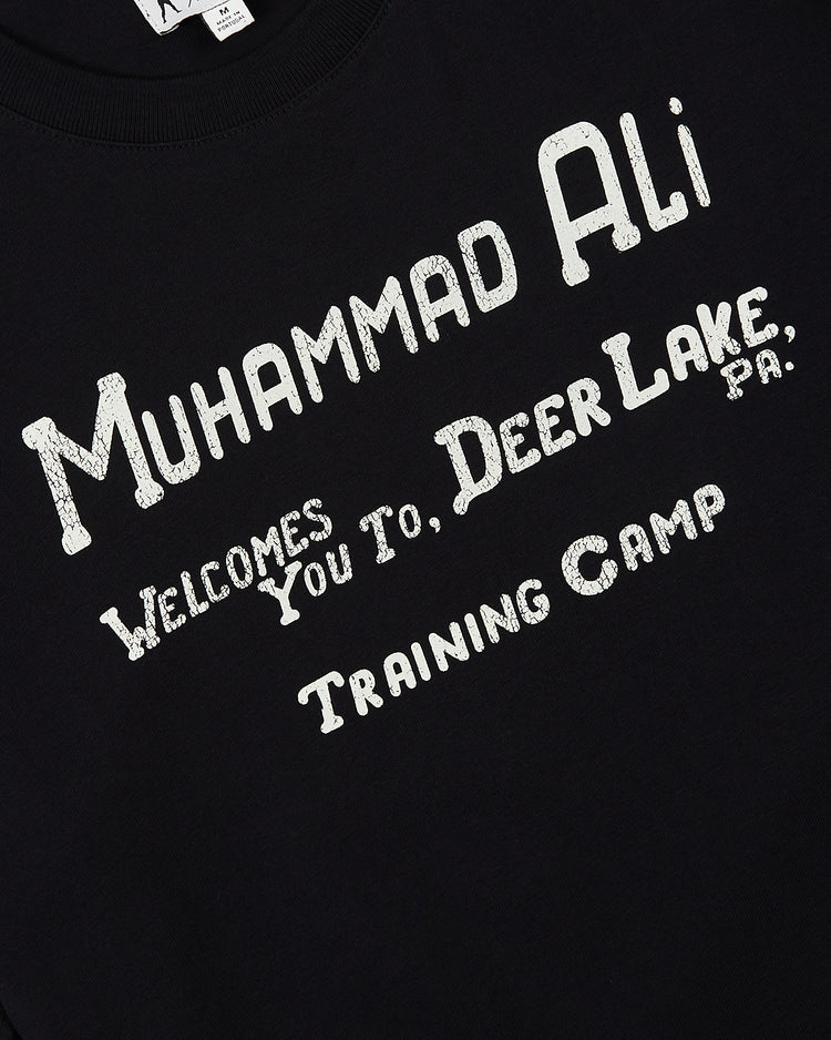 The Ebbets Field Muhammad Ali 'Deer Lake Training Camp' Short Sleeve Graphic Tee features white, distressed 