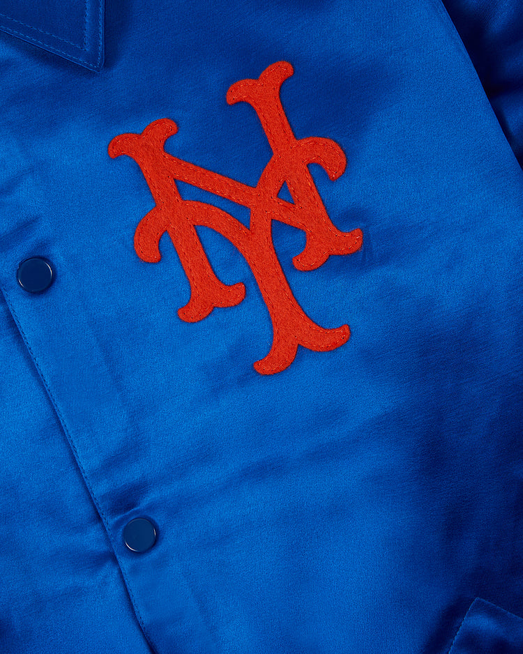 Close-up of the EFF New York Mets 1969 Satin Windbreaker Jacket in royal blue, featuring a red NY monogram patch and blue snap buttons, inspired by vintage team windbreakers and the legendary 1969 Miracle Mets.