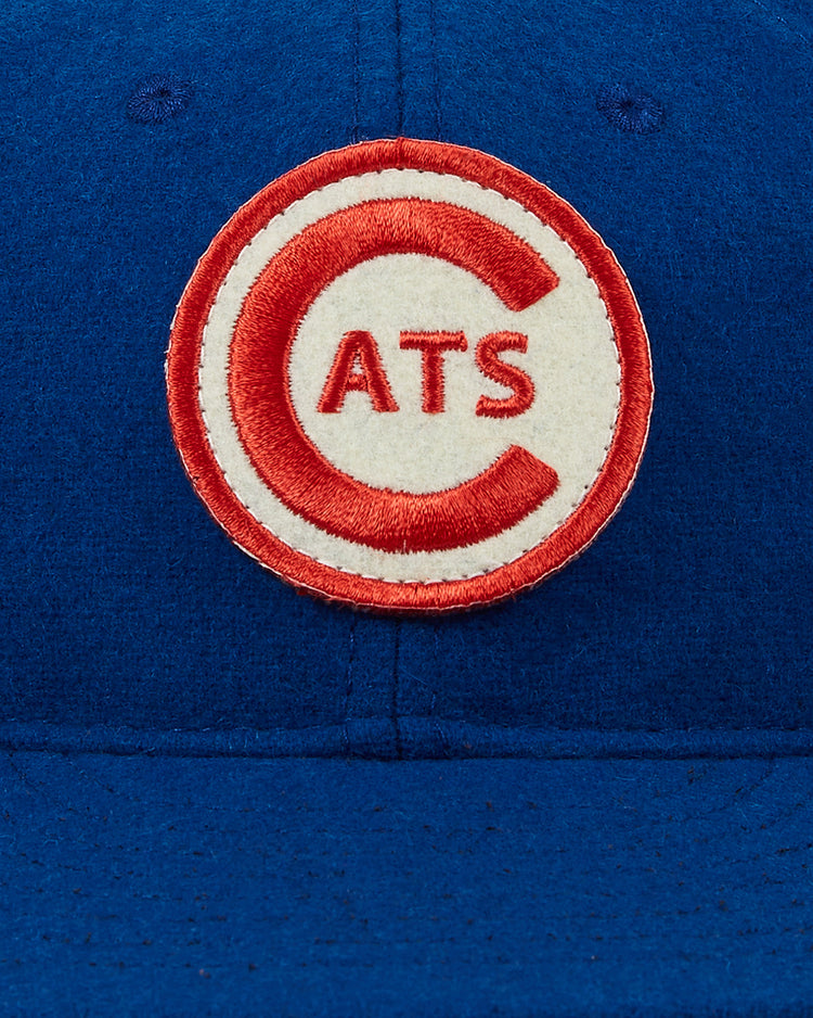 A close-up of the EFF Fort Worth Cats 1959 Authentic Wool Ballcap, showcasing a round embroidered patch with a red 