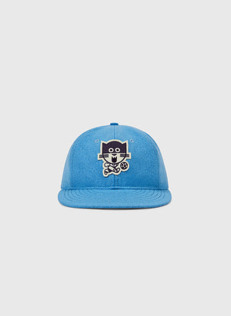 EFF's Chicago Cats 1976 Authentic Wool Ballcap features a blue design with a cartoon dog holding a soccer ball, inspired by the American Soccer League team, shown on a plain light gray background.