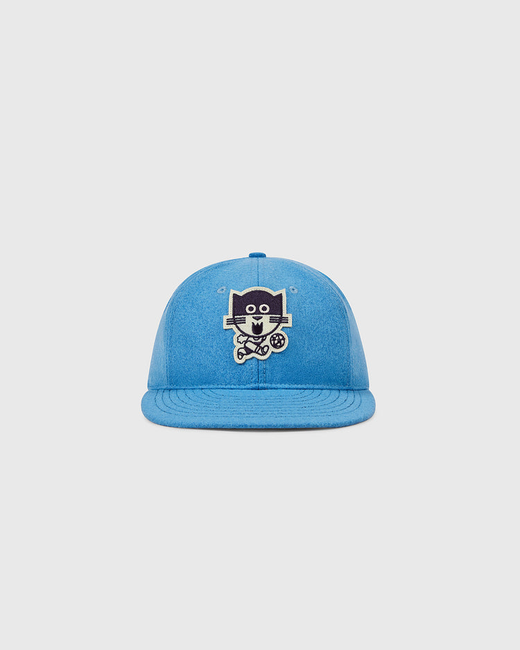 EFF's Chicago Cats 1976 Authentic Wool Ballcap features a blue design with a cartoon dog holding a soccer ball, inspired by the American Soccer League team, shown on a plain light gray background.