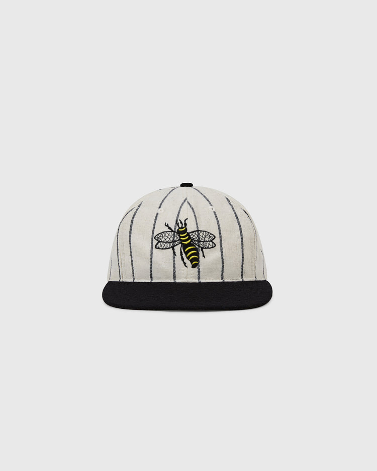 The EFF Chicago Cats 1976 Authentic Wool Ballcap features a cream base with black pinstripes, a black brim, and an embroidered yellow and black bee inspired by the original team logo.