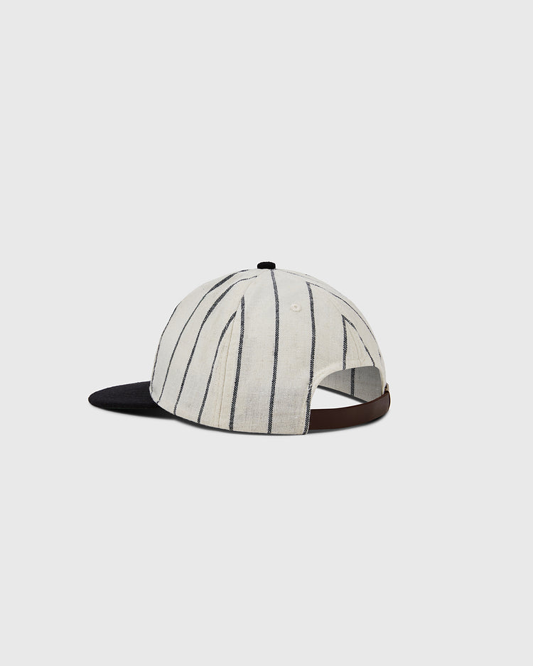 The EFF Chicago Cats 1976 Authentic Wool Ballcap features white wool with thin black stripes, a black brim, and a brown adjustable strap, inspired by the vintage soccer logo. Shown on a plain light gray background.
