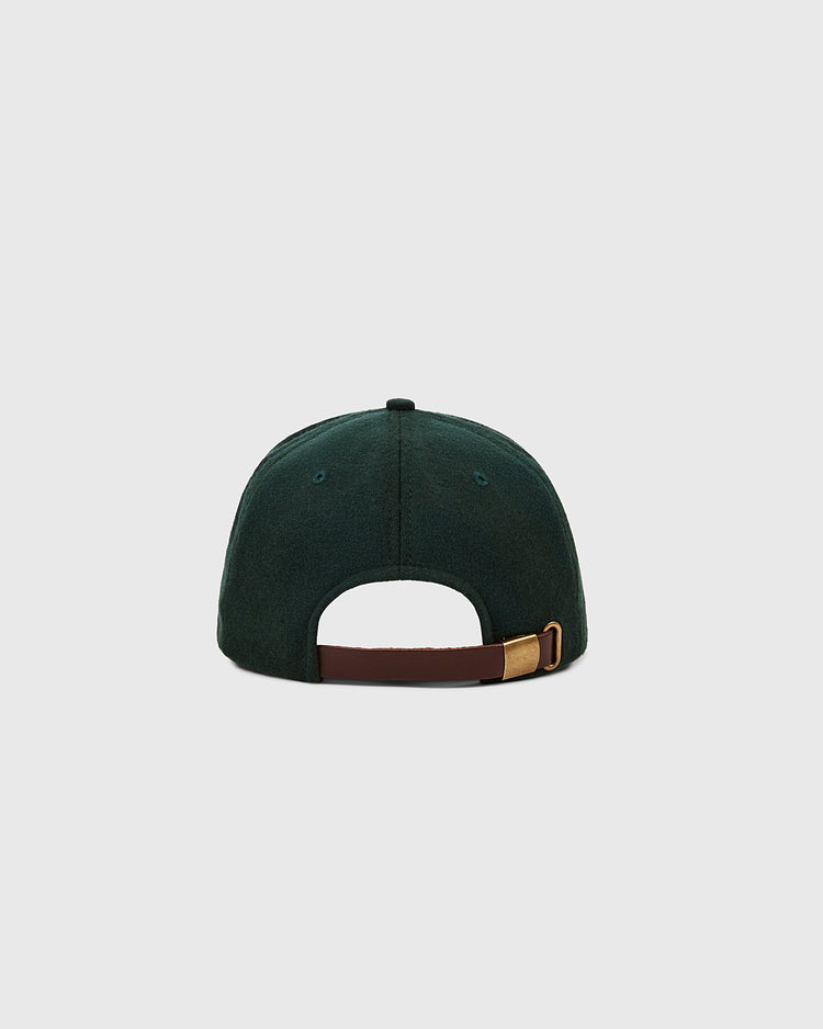 The Ebbets Field Ebbets Felt 'E' Wool Ballcap, in dark green wool broadcloth, is shown from the back with a brown adjustable strap and brass buckle against a plain light gray background.