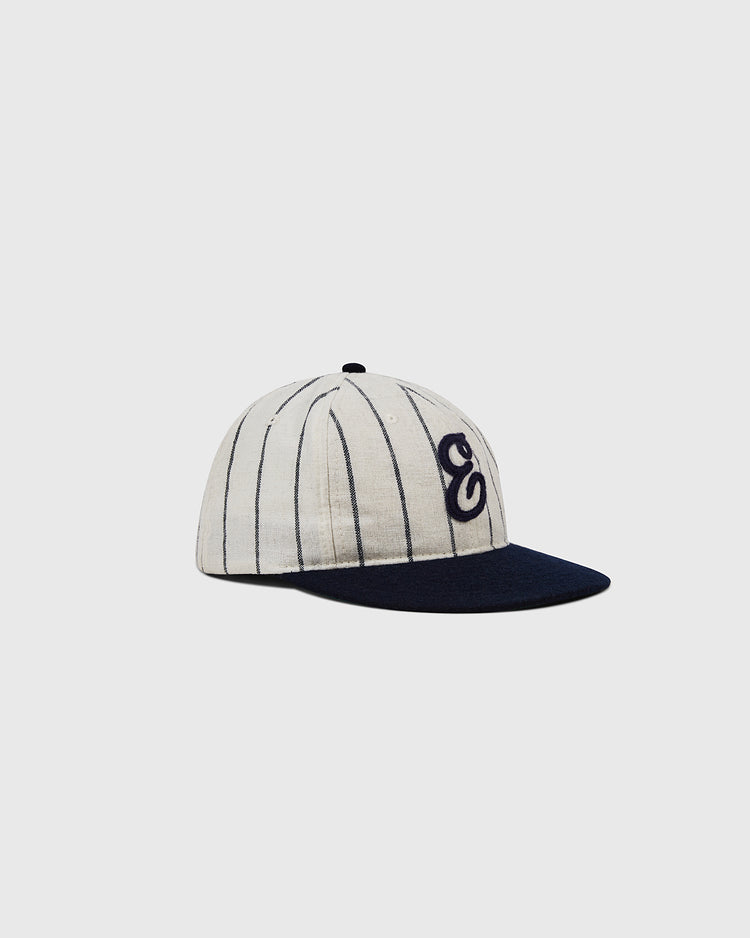 The Ebbets Felt 'E' Wool Pinstripe Ballcap by Ebbets Field features thin black pinstripes, a navy blue brim, and a stylized black 