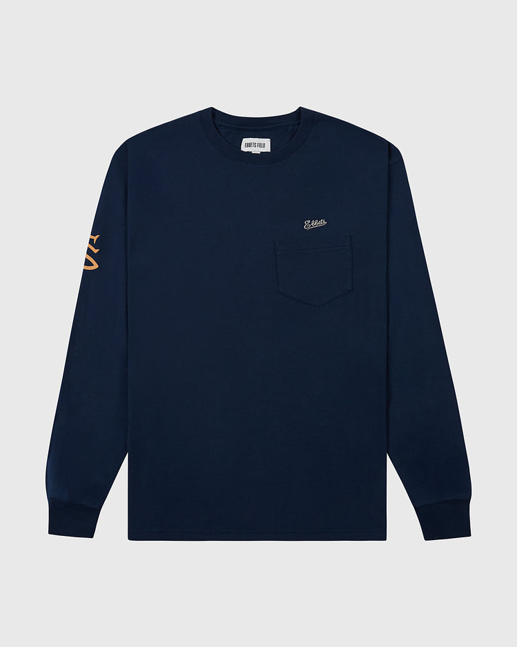 The Ebbets Field San Francisco Seals (PCL) Long Sleeve Graphic Tee features navy blue fabric, a chest pocket with small embroidery, and bold orange sleeve graphics—ideal for Pacific Coast League fans. Shown on a light gray background.
