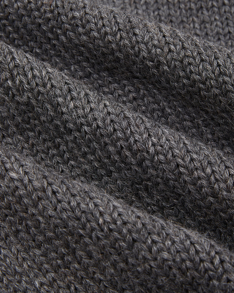 Close-up of dark gray, ribbed wool fabric with visible texture from the Ebbets Field New York Yankees 1922 Wool Shawl Collar Sweater.