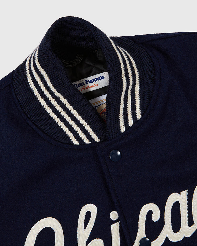 Close-up of a navy blue Chicago White Sox 1967 Authentic All Wool Varsity Jacket by EFF, featuring white striped ribbed collar, snap buttons, and 