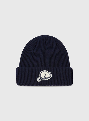 The Ebbets Field Portland Beavers Felt Logo Ribbed Beanie is a navy ribbed knit with a folded brim and a white beaver felt patch on the front, set against a plain light gray background—ideal for Portland Beavers fans.