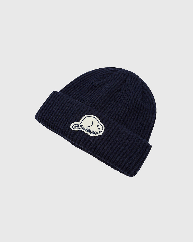 The Ebbets Field Portland Beavers Felt Logo Ribbed Beanie features dark blue ribbed knit, a folded brim, and a white beaver patch—ideal for Portland Beavers fans and classic PCL baseball collectors. Photographed on a plain light background.