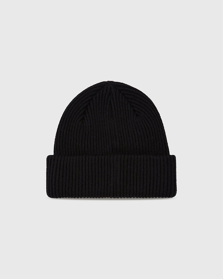 The Ebbets Field New York Black Yankees Felt Logo Ribbed Beanie features a black, ribbed knit with a folded brim, inspired by the Negro National League, displayed on a plain light gray background.