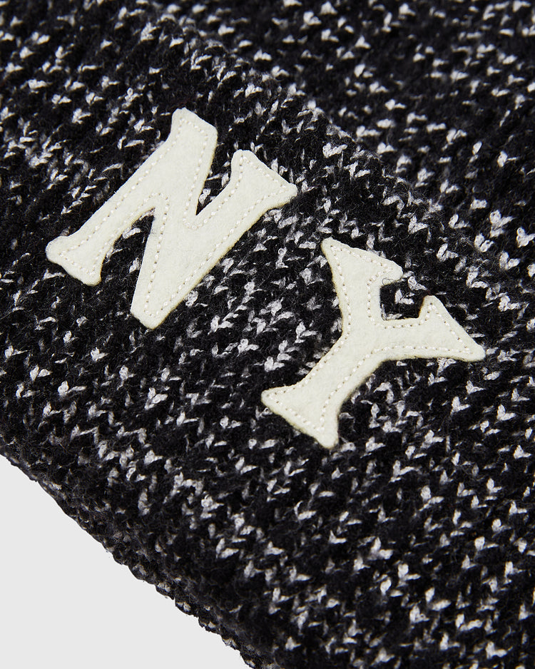 Close-up of the Ebbets Field New York Black Yankees Felt Logo Ribbed Beanie, featuring bold white “NY” lettering inspired by the historic team.